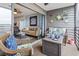 Open-concept living room and kitchen with access to the screened patio at 123 N Dogwood St. # 107, Garden City Beach, SC 29576