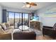Comfortable living room featuring a ceiling fan, waterfront view, and beach-themed decor at 123 N Dogwood St. # 107, Garden City Beach, SC 29576
