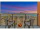 Scenic balcony view at dusk with seating and fruit bowl, overlooking the city and ocean at 1501 Ocean Blvd. S # 607, Myrtle Beach, SC 29577