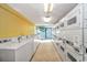 Well-lit laundry room with multiple white washers and dryers, some marked as 'out of order' at 1501 Ocean Blvd. S # 607, Myrtle Beach, SC 29577
