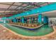 Enjoy the serene lazy river with lush greenery and vibrant blue accents for ultimate relaxation at 1501 Ocean Blvd. S # 607, Myrtle Beach, SC 29577