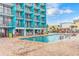 Outdoor pool and seating area with people enjoying the sun and a bar nearby at 1501 Ocean Blvd. S # 607, Myrtle Beach, SC 29577