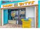 Exterior view of Shark Bites restaurant with a yellow garbage bin in front of it at 1501 Ocean Blvd. S # 607, Myrtle Beach, SC 29577