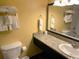 A bathroom featuring a sink with a granite countertop, toilet, and towel rack at 1501 S Ocean Blvd. # 1203, Myrtle Beach, SC 29577