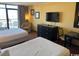 Bright bedroom with two beds, a TV, dresser, and access to the balcony at 1501 S Ocean Blvd. # 1203, Myrtle Beach, SC 29577