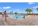 Outdoor pool with palm trees, brick pavers, and resort guests enjoying the sunshine at 1501 S Ocean Blvd. S # 1147, Myrtle Beach, SC 29577