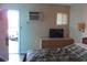 This bedroom offers an air conditioner, TV, and access to the exterior at 1600 S Ocean Blvd. # 148, Myrtle Beach, SC 29577