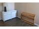 Cozy bedroom features a white dresser, a lamp, and a small, wooden shelf at 1600 S Ocean Blvd. # 148, Myrtle Beach, SC 29577