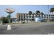 View of the Wave Rider hotel with swimming pool and palm trees at 1600 S Ocean Blvd. # 148, Myrtle Beach, SC 29577