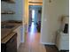 A hallway with tan tile flooring leads from the kitchen to a bedroom at 1600 S Ocean Blvd. # 148, Myrtle Beach, SC 29577