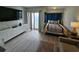 This cozy room has a balcony with an ocean view, sleek white storage, and a plush bed, creating a tranquil retreat at 1605 South Ocean Blvd. # 1902, Myrtle Beach, SC 29577