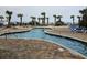 Picturesque lazy river pool with brick surroundings, palm trees, and blue water, perfect for relaxation and leisure at 1605 South Ocean Blvd. # 1902, Myrtle Beach, SC 29577