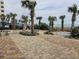 Beautiful pool area with lush landscaping and palm trees, perfect for relaxing by the ocean at 1605 South Ocean Blvd. # 1902, Myrtle Beach, SC 29577