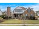 Charming brick home featuring blue shutters, manicured lawn, and a welcoming front entrance at 1909 Bingham Ct., Myrtle Beach, SC 29588