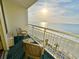 Balcony overlooking the beach with chairs and table, perfect for relaxing and enjoying the ocean view at 201 S Ocean Blvd. # 717, Myrtle Beach, SC 29577
