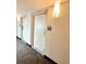 Hallway with a door to unit 717, lit with sconces, and a carpeted floor at 201 S Ocean Blvd. # 717, Myrtle Beach, SC 29577