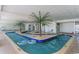 Indoor lazy river with palm trees, lounge chairs, and blue floats for relaxation at 201 S Ocean Blvd. # 717, Myrtle Beach, SC 29577