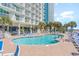 Outdoor pool with sundeck, lounge chairs, and palm trees for a relaxing resort experience at 201 S Ocean Blvd. # 717, Myrtle Beach, SC 29577