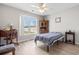 Cozy bedroom features a ceiling fan, a large window, and wooden furniture at 2029 Hawksmoor Dr., Conway, SC 29526
