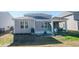 Spacious backyard featuring a patio area, screened porch, and lush green lawn, perfect for outdoor entertaining at 204 Juniata Loop, Little River, SC 29566