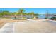 Scenic backyard with lake view, palm trees, fire pit area, and waterfront dock at 204 Juniata Loop, Little River, SC 29566