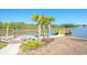 Beautiful backyard with waterfront view, palm trees, a fire pit, and a wooden dock at 204 Juniata Loop, Little River, SC 29566