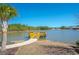 Scenic view of a lake with a wooden dock, sandy beach, and mature landscaping at 204 Juniata Loop, Little River, SC 29566