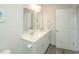 Bathroom featuring double sinks, white cabinets, chrome fixtures, and gray tile flooring at 204 Juniata Loop, Little River, SC 29566