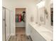 Bright bathroom featuring double sinks, walk-in closet and glass shower at 204 Juniata Loop, Little River, SC 29566