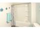 Bright bathroom featuring a tub with shower, gray curtain, and charming turtle decor at 204 Juniata Loop, Little River, SC 29566