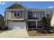 Charming two-story home with a two-car garage, stone accents, and a well-manicured front yard at 204 Juniata Loop, Little River, SC 29566