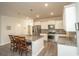 Bright kitchen featuring stainless appliances, granite counters, a kitchen island with bar stool seating, and neutral backsplash at 204 Juniata Loop, Little River, SC 29566