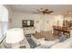 Open-concept living room showcasing a ceiling fan, comfortable seating, and seamless flow to the kitchen at 204 Juniata Loop, Little River, SC 29566