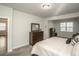 Spacious main bedroom with a dresser, large window, neutral carpeting and ensuite access at 204 Juniata Loop, Little River, SC 29566