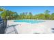 Community pool with a spacious deck, surrounded by trees and lush landscaping at 204 Juniata Loop, Little River, SC 29566