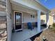 Cozy front porch with comfortable seating, stone accents, and a welcoming entrance at 204 Juniata Loop, Little River, SC 29566
