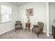 Cozy sitting room with patterned chairs, neutral walls, a window with blinds, and carpeted flooring at 204 Juniata Loop, Little River, SC 29566