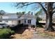 Backyard with patio seating, barbecue grill, and mature tree that provides ample shade at 213 S Farr Ave., Andrews, SC 29510