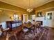Elegant dining room featuring a large table, chandelier lighting, and a fireplace at 213 S Farr Ave., Andrews, SC 29510