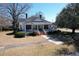 Sprawling front yard leading to a classic home with a wide, inviting front porch and mature trees at 213 S Farr Ave., Andrews, SC 29510