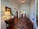 Inviting foyer with hardwood floors, a vintage rug, and tasteful decor sets a welcoming tone at 213 S Farr Ave., Andrews, SC 29510