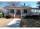 Charming two-story home featuring a classic wrap-around porch with columns and a well-manicured front yard at 213 S Farr Ave., Andrews, SC 29510