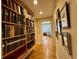 Inviting hallway with beautiful hardwood floors and floor-to-ceiling custom-built bookshelves at 213 S Farr Ave., Andrews, SC 29510