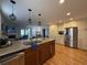 Open-concept kitchen with island, granite countertops, stainless steel appliances, and hardwood floors at 213 S Farr Ave., Andrews, SC 29510
