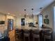 Bright kitchen with white cabinets, granite countertops, kitchen island with barstool seating and stainless steel appliances at 213 S Farr Ave., Andrews, SC 29510