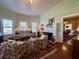Cozy living room with large windows, a fireplace, and comfortable seating creating a warm atmosphere at 213 S Farr Ave., Andrews, SC 29510