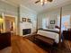 Bright main bedroom with a four-poster bed, fireplace, and hardwood floors at 213 S Farr Ave., Andrews, SC 29510