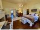 Spacious main bedroom with a fireplace, hardwood floors, and a decorative chandelier at 213 S Farr Ave., Andrews, SC 29510