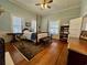 Bright main bedroom with a four-poster bed, fireplace, and hardwood floors at 213 S Farr Ave., Andrews, SC 29510
