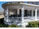 Inviting wraparound porch showcases classic columns, comfortable rocking chairs, and a relaxing porch swing at 213 S Farr Ave., Andrews, SC 29510